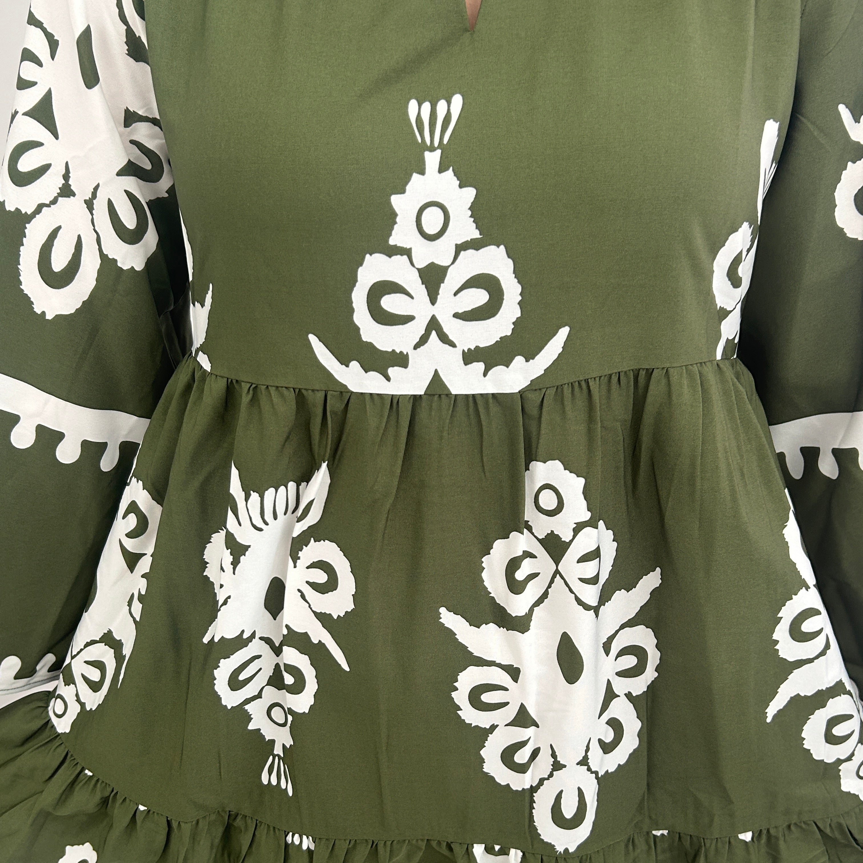 Green fabric with white floral patterns