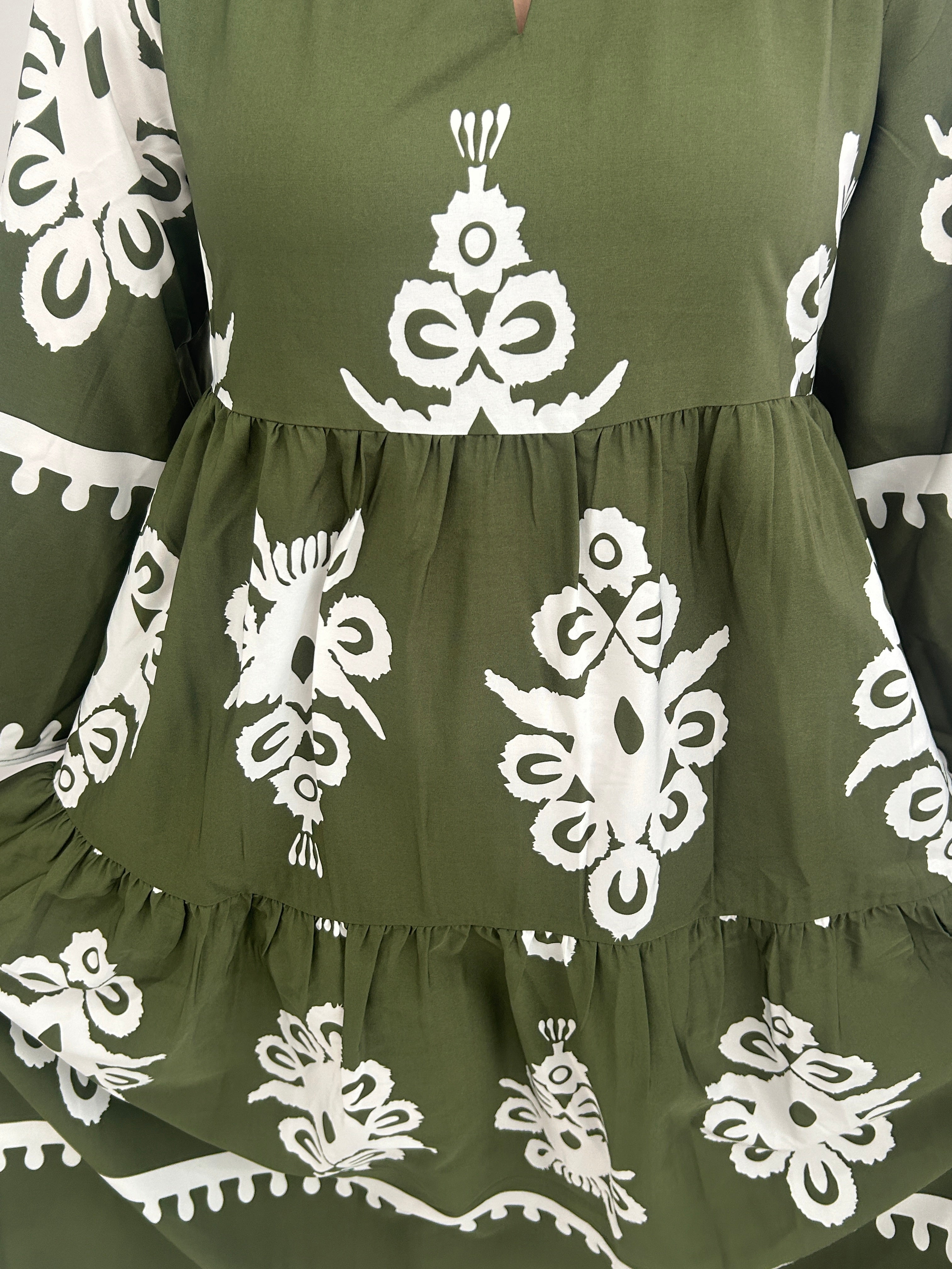 Green fabric with white floral patterns