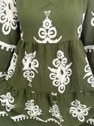 Green fabric with white floral patterns